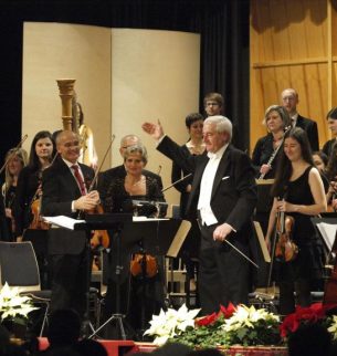 Chor mit Dirigent bekommen Applaus von Publikum