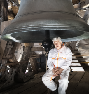 Sound artist Bill Fontana poses in front of a bell used for the project.